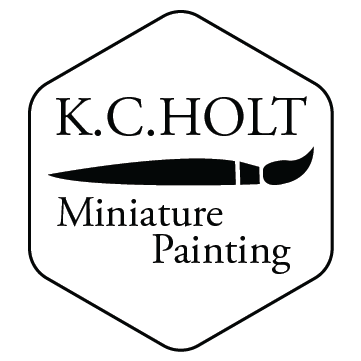 six sided shape with a brush in the center and the words K.C. Holt Miniature Painting